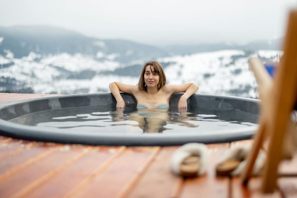 Woman bathing in hot tub at mountains
